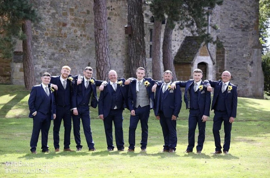 Groomsmen in navy suits hired from Scotney’s of London Road