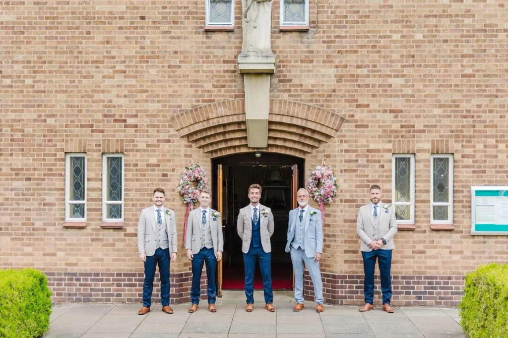 Wedding party in beige and grey jackets with navy trousers, hired from Scotney’s of London Road